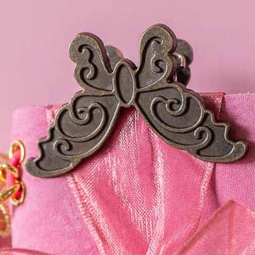 Pink notebook with decorative elements on a pink background